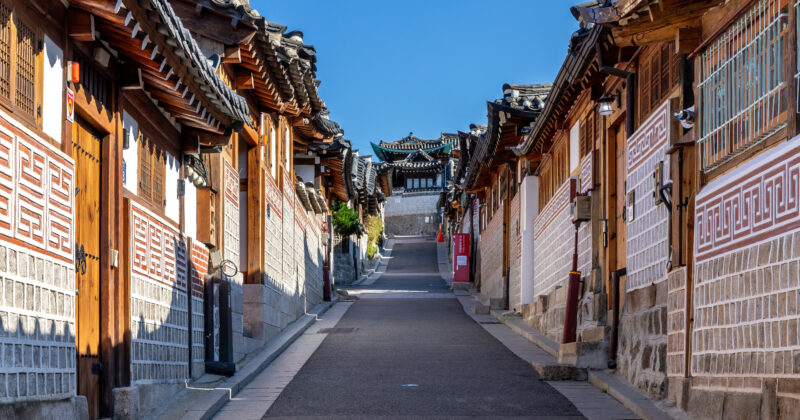 Traditional hanok houses lining a quiet street in Bukchon Hanok Village, Seoul